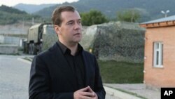 A mourner is seen through a barricade in Kyiv's Independent Square. 