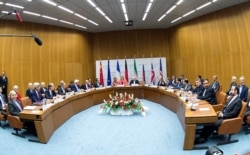 FILE - Participants in the Iran nuclear talks that culminated in the signing of the Joint Comprehensive Plan of Action are pictured during a meeting at the U.N. building in Vienna, Austria, July 14, 2015.