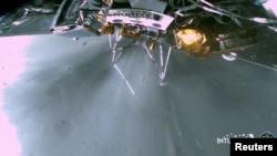The landing strut of the Odysseus lunar lander absorbs first contact with the lunar surface during its landing on the moon, as the liquid methane and liquid oxygen engine continues to throttle, Feb. 22, 2024. (Intuitive Machines via Reuters)