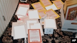 FILE - This image contained in a court filing by the Department of Justice on Aug. 30, 2022, and partially redacted by the source, shows a photo of documents seized during the Aug. 8 FBI search of former President Donald Trump's Mar-a-Lago estate.