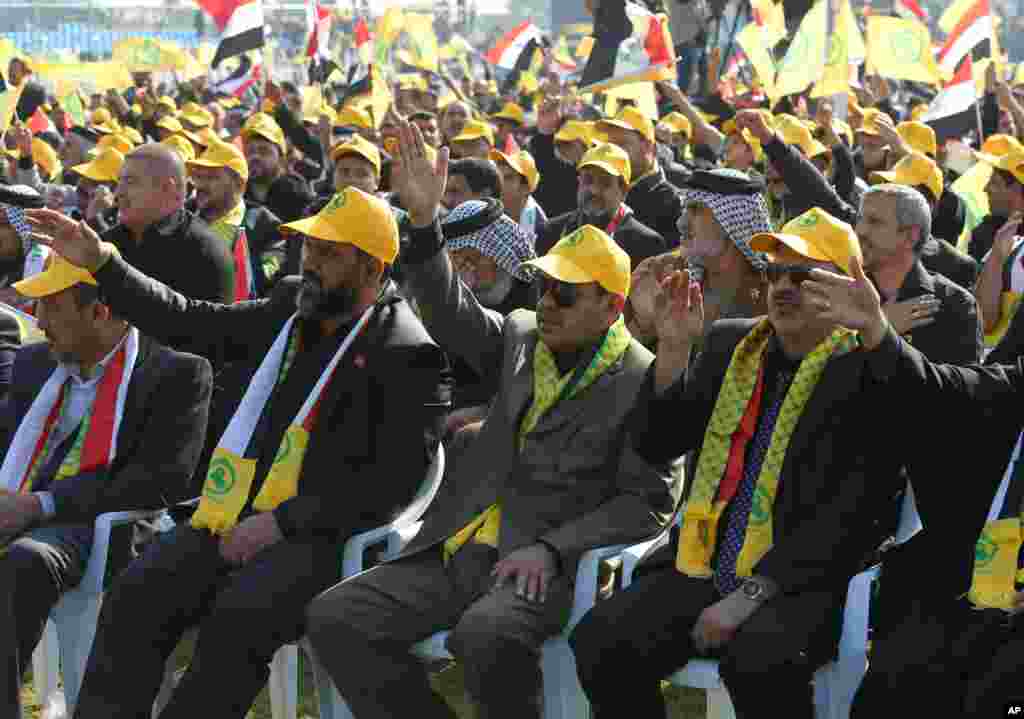 Supporters of Iraq's largest Shi'ite party, the Supreme Islamic Iraqi Council, listen to their leader, Ammar al-Hakim, during a rally to mark Muharram, Baghdad, Nov. 13, 2013.