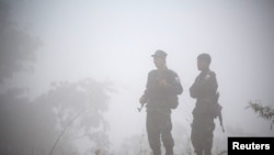 FILE - Fighters opposing Myanmar's military are seen in Kaw Thoo Lei, Kayin state, Myanmar, Jan. 31, 2019. Myanmar's army battled local militia fighters Saturday in the northwestern town of Mindat.