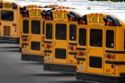 FILE - Fairfax County Public School buses are lined up at a maintenance facility in Lorton, Va., July 24, 2020.
