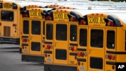 Fairfax County Public School buses are lined up at a maintenance facility in Lorton, Va., July 24, 2020.