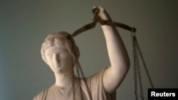 FILE - A Justice statue is pictured at a lawyer's office in Tehran, Iran, May 9, 2011.