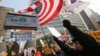 FILE - South Korean protesters wave U.S. and South Korean flags at a rally to support the deployment of THAAD, an advanced U.S. missile defense system, Feb, 15, 2017. 