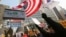 FILE - South Korean protesters wave U.S. and South Korean flags at a rally to support the deployment of THAAD, an advanced U.S. missile defense system, Feb, 15, 2017. 