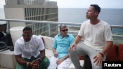 (L-R) Members of the Cuban fusion group Orishas, Yotuel, Roldan and Ruzzo, give an interview from the top of a building in Havana, Cuba, June 22, 2016. 