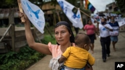 A supporter of the Agricultural People's Front of Peru, known by its acronym, Frepap, waves a party banner during a campaign rally in San Pablo, Peru, March 30, 2021.