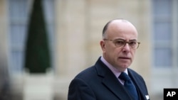 FILE - Then-French Interior minister Bernard Cazeneuve gives a press conference at the Elysee Palace.