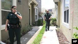Orange County Sheriff's deputies check on a townhouse owned by Minneapolis police officer Derek Chauvin, May 29, 2020, in Windermere, Fla. 