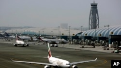 FILE - An Emirates Airline passenger jet taxis on the tarmac at Dubai International airport in Dubai, United Arab Emirates, April 20, 2010. Disrupted by the virus, the world's busiest airport ‘s passenger numbers have dropped drastically.