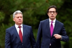 FILE - Newly elected President of North Macedonia Stevo Pendarovski, right, walks with outgoing president Gjorge Ivanov, during his inauguration ceremony in Skopje, North Macedonia, May 12, 2019.