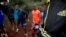 FILE - an athlete sets the timer on his watch before starting to run with others in Kaptagat Forest in western Kenya. 