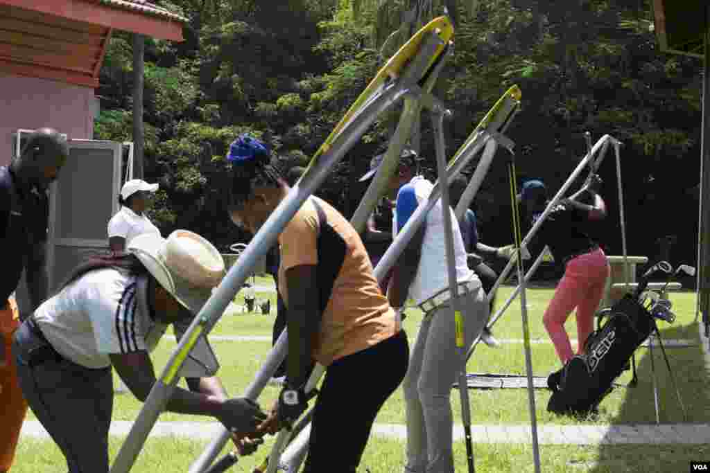 Mbuko guides her students to practice their hip rotation. She has slowed down from competing and dedicates her time these days to training Nigerian female golfers to become pros. (Chika Oduah for VOA)