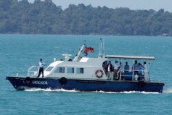 A speed boat transports samples from some passengers who have reported stomachaches or fever, in the Westerdam, anchored off Sihanoukville, Cambodia, Feb. 13, 2020.