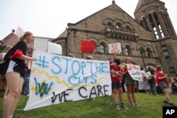 FILE - West Virginia University students lead a protest against cuts to programs in world languages, creative writing and more amid a $45 million budget deficit outside Stewart Hall in Morgantown, W.Va., on Aug. 21, 2023. (AP Photo/Leah Willingham)
