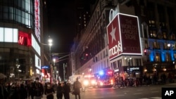 New York police officers park their vehicles outside Macy's store after it was broken into hours after a solidarity rally calling for justice over the death of George Floyd, June 1, 2020, in New York.