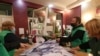 Members of a local election commission empty a ballot box before counting votes during the municipal elections in Tbilisi, Georgia, Oct. 2, 2021.