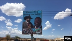 A billboard in South Sudan's capital Juba on April 15, 2016 shows South Sudan's President Salva Kiir (L), and rebel leader Riek Machar (R), who is scheduled to return to the city and assume the vice presidency on Monday. (VOA/J. Patinkin)