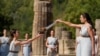 Greek actress Xanthi Georgiou, playing the role of the High Priestess, lights the torch during the flame lighting ceremony for the Beijing 2022 Winter Olympics at the Ancient Olympia archeological site, birthplace of the ancient Olympics in southern Greece, Oct. 18, 2021. 