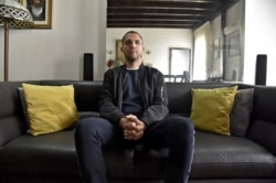 FILE - Khaled Drareni, Algerian journalist for France's TV5 Monde and NGO Reporters Without Borders (RSF), and who has become a symbol of the struggle for a free press, poses for a photo at his home in Algiers, Feb. 23, 2021.