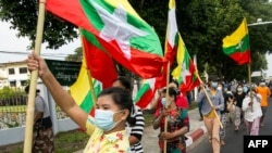 Military supporters wave Myanmar national flags during a protest to demand an inquiry to investigate the Union Election Commission (UEC) in Yangon on Jan. 29, 2021, as fears swirl about a possible coup by the military over electoral fraud concerns.