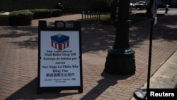 FILE - A sign is seen outside a mail ballot drop-off site after Gov. Greg Abbott issued an order limiting each Texas county to one mail ballot drop-off site in Houston, Texas, Oct. 1, 2020. 