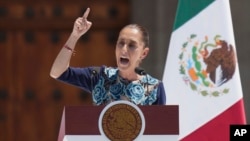 FILE - President Claudia Sheinbaum addresses supporters at a rally she convened to welcome U.S. President Donald Trump's decision to postpone tariffs on Mexican goods for one month at the Zocalo, Mexico City's main square, March 9, 2025.