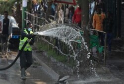 FILE - An Ethiopian health worker sprays disinfectant as part of measures to prevent the potential spread of coronavirus (COVID-19), in Addis Ababa, Ethiopia, March 29, 2020.