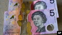 FILE - Australian $5 notes are pictured in Sydney on Sept. 10, 2022. King Charles III won’t feature on Australia's new $5 bill, the nation's central bank announced Thursday, Feb. 2, 2023.