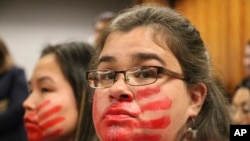 FILE - Joanne Sakar, left, and Natasha Gamache at the arraignment for Brian Steven Smith, who faces 14 charges in the deaths of two Alaska Native women, in Anchorage, Alaska, Oct. 21, 2019.