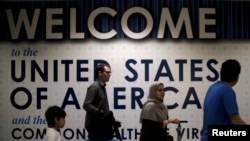 FILE - International passengers arrive at Washington Dulles International Airport, Virginia, June 26, 2017.