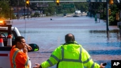 People look at U.S. Route 206, flooded as a result of the remnants of Hurricane Ida, in Somerville, N.J., Sept. 2, 2021. 