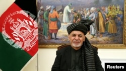 FILE - Afghanistan's President Ashraf Ghani speaks during a live TV broadcast at the presidential palace in Kabul, Afghanistan, Jan. 28, 2019. 