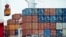  FILE- A container is loaded onto a cargo ship at the Tianjin port in China, Aug. 5, 2010. 