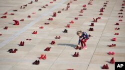 A display of hundreds of red shoes spread as protest against violence toward women in Israel at Habima Square in Tel Aviv, Israel, Tuesday, Dec. 4, 2018. 