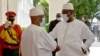 Mali’s President Ibrahim Boubacar Keita, at right, and Senegal’s President Macky Sall exchange COVID-era greetings at the Sheraton Bamako Hotel in the Malian capital, July 23, 2020. (Photo by Modibo Dembele/VOA)