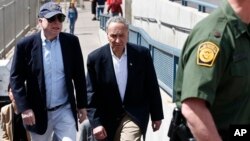 U.S. Senator John McCain, left, and Senator Charles Schumer tour the Nogales port of entry during their tour of the Mexico border with the United States, March 27, 2013, in Nogales, Arizona.