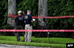Members of FBI are seen at the crime scene outside the Trump International Golf Club in West Palm Beach, Florida, on September 15, 2024 following a shooting incident at former US president Donald Trump's golf course.