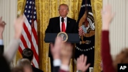 President Donald Trump looks at reporters during a news conference in the East Room of the White House in Washington, Feb. 16, 2017. 