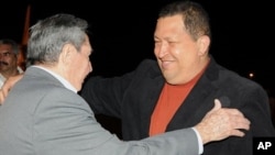 In this photo released by Cuba's state-run Granma newspaper, Cuba's President Raul Castro, left, welcomes Venezuela's President Hugo Chavez upon his arrival to Havana, Cuba, Friday Feb. 24, 2012. Chavez arrived in Cuba for urgent surgery to remove a tumor