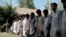 FILE - Arrested Islamic State fighters stand outside the Afghan police headquarters in Jalalabad, Nangarhar, east of Kabul, Afghanistan, May 9, 2016.