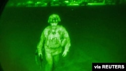 U.S. Army Major General Chris Donahue, commander of the 82nd Airborne Division, steps on board a C-17 transport plane as the last U.S. service member to leave Hamid Karzai International Airport in Kabul, Afghanistan, Aug. 31, 2021.
