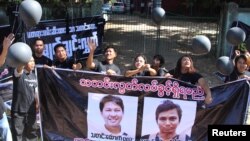 FILE - Journalists take part in a protest outside the court where Reuters journalists Wa Lone and Kyaw Soe Oo attend a hearing in Yangon, Myanmar, Jan. 10, 2018.