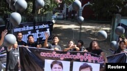 FILE - Journalists take part in a protest outside the court where Reuters journalists Wa Lone and Kyaw Soe Oo attend a hearing in Yangon, Myanmar, Jan. 10, 2018.