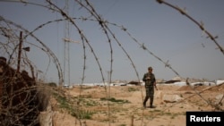 A member of Palestinian security forces loyal to Hamas patrols at the border between Egypt and the Gaza Strip, March 4, 2014. 