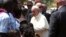 Pope Francis greets internally displaced people sheltering on the grounds of the Saint Sauveur church, during his visit in the capital Bangui, Central African Republic, Nov. 29, 2015.