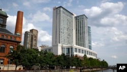 FILE - Marriott Hotel in Baltimore's Harbor East district, June 29, 2017. In sales brochures, a U.S. company boasted of the “stunning visual effect” its shimmering aluminum panels created in a 33-story hotel on Baltimore’s waterfront. Those same panels also were used in London’s Grenfell Tower. 