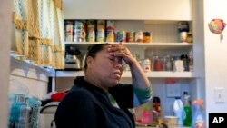 A volunteer prepares bags with groceries for delivery at The Campaign Against Hunger food pantry, April 16, 2020, in the Bedford-Stuyvesant neighborhood of the Brooklyn borough of New York